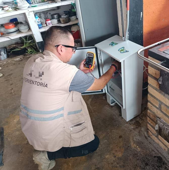 Interventor midiendo un tablero eléctrico con multímetro